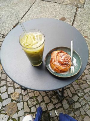 Cold matcha latte with vegan cinnamon roll at Calm Coffee in Berlin