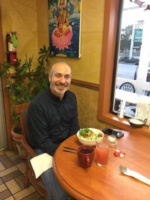 Customer enjoying the new night time menu's Buddah Bowl at Good Karma Cafe in Gulfport