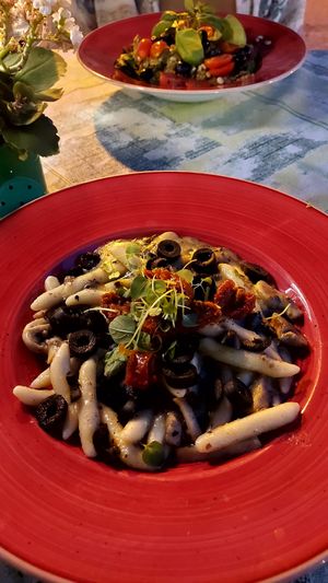 In the front: istrian pasta with truffles, dried tomatos and olives. In the back: quinoa with mixed vegetables and pesto. at Bookeria in Rovinj