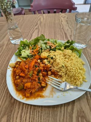 Moroccan Tajin Stew with vegetables of the season, chickpea, couscous and salad at Sattva Vegan in Vienna
