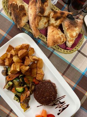 Vegan burger with potatoes and vegetables + italian pizza bread with garlic at Braavos in Banjole