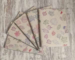 Handmade notebooks, made out of grass paper, with hand decorated covers at La Cosa Vegana in Granada