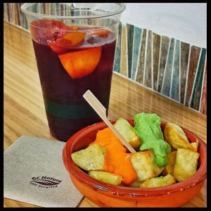 Dia de la Hispanidad: especial platos españoles Sangría y tapa de patatas con mojo picón y mojo verde at La Cosa Vegana in Granada