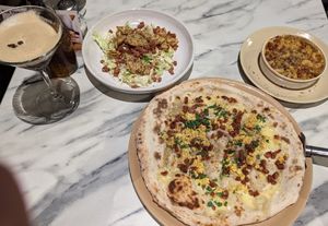 Pictured from left to right - espresso martini, caesar salad, carbonara pizza, mac & cheese at Purezza in Manchester