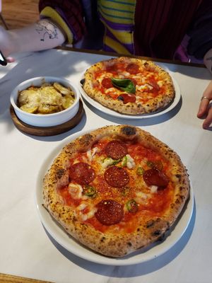 (Front to back) pepperoni pizza, slow roasted potatoes, margarita pizza with added pepperoni at Purezza in Manchester