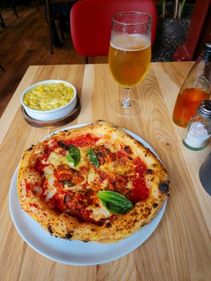 Aubergine parmigiana pizza, mac & cheese with a bottle of offensively bland chilli oil and salt dispenser at Purezza in Manchester