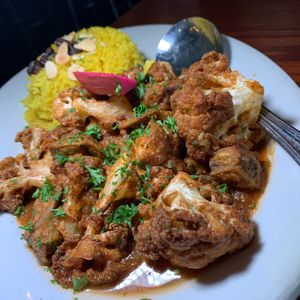 Veggie Cauliflower & Eggplant:  Sautéed Cauliflower and Eggplant in a Spicy Tomato Sauce, served with Rice at Zooroona Restaurant and Lounge in Kalamazoo