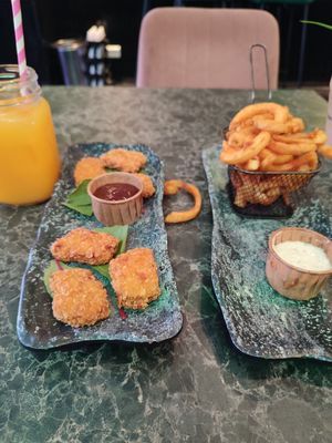 Nuggets with BBQ sauce, twister fries with garlic mayo and fresh orange juice at Vegan Temple Bar in Amsterdam