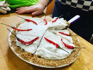 Customs pie 🚨 tortilla chip crust, chocolate pudding filling, coconut cream up top, and candied chili peppers to finish at The Indignant Platypus in Louisville
