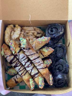 Big box! Filled with Chocolate mint cannolis, strawberry lemon rolls and galas green rolls! at The Indignant Platypus in Louisville