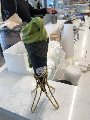 Matcha soft serve ice cream in charcoal cone at Whisk Matcha Cafe in Vancouver