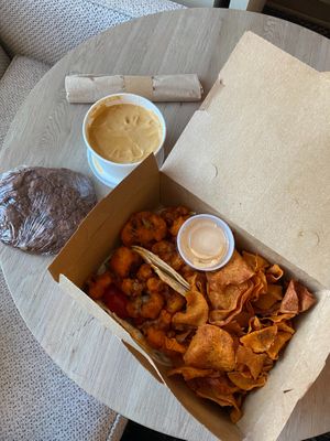Buffalo Cauliflower Tacos, Sweet Potato Chips, Vegan Queso, and A big Chocolate Almond Chunk Brownie  at Laughing Seed Cafe in Asheville