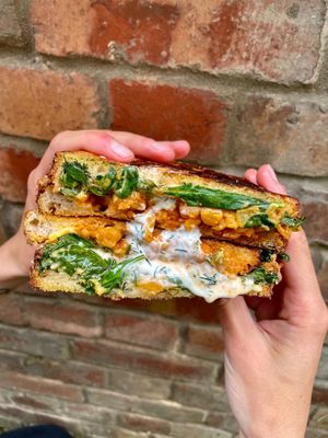 Buffalo-style chickpeas with fresh herb ranch dressing, cheese + greens at Plant the Seed in Hastings