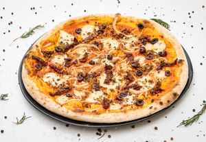 Potatoes, onions, sundried tomatoes, Kalamata black olives, homemade vegan mozzarella cheese, homemade vegan sausage, rosemary, Kampot black pepper, extra-virgin olive oil. at Fellini in Siem Reap