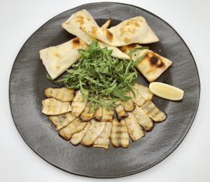 Carpaccio di Funghi.
Grilled Oyster Mushrooms, homemade vegan Parmesan cheese, rocket, lemon, Kampot pepper, extra-virgin olive oil, served with focaccia bread. at Fellini in Siem Reap