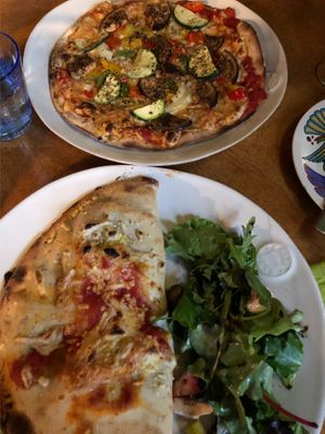 Vegan pizza and vegan calzone with side salad  at Sassy's in Oostende