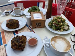 Vegan pumpkin bakes, avocado tostado with green tomatoes and rocket, and veganised salad; the smoothie didn’t last long enough to make the photo!   at Good Stuff Cafe in Nerja