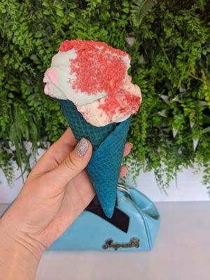Raspberry ripple topped with candyfloss and sherbet in a colourful cone at Lick in Holmfirth
