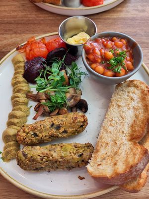 Plant breakfast featuring homemade sausages, hummus, beetroot, mushrooms, toast, homemade baked beans at Rustic Cup in Whitley Bay