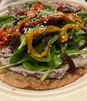 Galette bretonne topped with black beans and peanut sauce, peppers and caramelised onions at Col Cavolo - Vegan Bistrot in Rome
