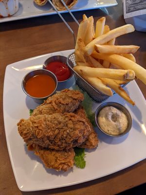 Vegan chicken tenders with buffalo sauce and a side of fries. at Bat 17 in Lombard