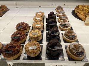 Various fine patisserie options, all labeled  at Land & Monkeys - Amsterdam in Paris