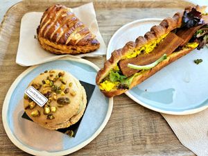 Delicious bacon mimosa sandwich, chausson au pommes and pistachio macaron at Land & Monkeys - Amsterdam in Paris