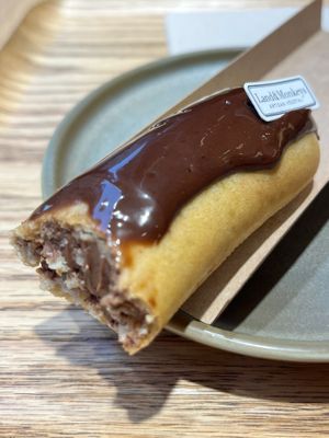 A decadent vegan eclair with chocolate. at Land & Monkeys - Amsterdam in Paris