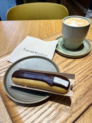 Eclair with chocolate and cafe latte, together 10,50€ (+0,50€ added to the eclair if eating on location). at Land & Monkeys - Amsterdam in Paris