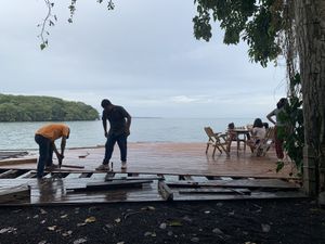 Building decking without edge protection whilst inviting kids to sit on completed areas  at El Pital in Ometepe