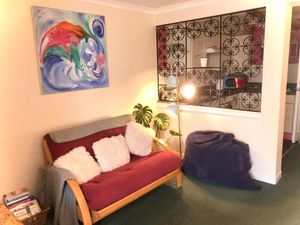 The living room with comfy big bean bags (and sofa bed for extra guests) at Tin Lid Cottage in Banton