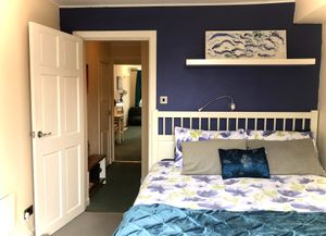 The bedroom (with kingsize bed) at Tin Lid Cottage in Banton