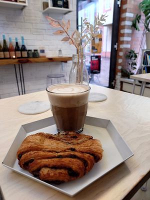 Foamy delicious chai latte with a huge chocolate cinnamon croissant. The salted peanut chocolate bar was exactly what the name says. at Shluk in Trier