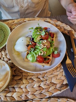 Waffles w avocado, tomato, pesto, pine nuts (ask to put the poached egg on the side for husband) at Noranta Tres in Escaldes-engordany