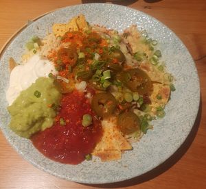 VEGAN NACHOS SHARER: TORTILLA CHIPS, VEGAN CHILLI,TOMATO SALSA, GUACAMOLE, VEGAN MAYO, VEGAN CHEESE & JALAPENDS at King Street Kitchen in Knutsford
