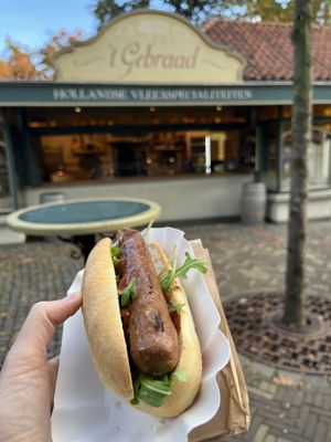 An outside stall attached to part of the main food area. The grilled sausage is the hot dog but rested on a hot griddle. They also cook other food on that griddle    at Efteling in Kaatsheuvel