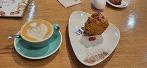 Flat white with oat milk and vegan carrot cake at Art Food Corner in Funchal