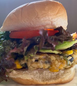 Southwest Burger with Avocado. Tasty spicy black bean patty from brown rice, black bean, jalapeño, corn, vegan cheese, lettuce, tomato, onion & vegenaise. Gluten free bread option at Berrybrook Farms in Charlotte