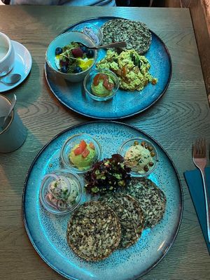 Two breakfast plates, one with scrambled tofu and one with three spreads at Emmi's Kitchen in Augsburg