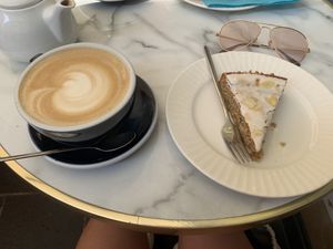 Vegan almande Cake with oat latte (the cake wasn’t labelled vegan but gluten free, after asking said was).  at HUG Cafe in Nice