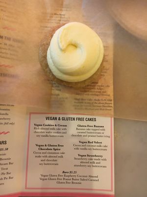 Lemon vegan cupcake, plus menu highlighting vegan items at Little Cupcake Bakeshop in New York City