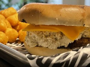 Vegan Sausage, Egg n Cheese Bagel with tater tots  at Your Local Seitanist in Chattanooga