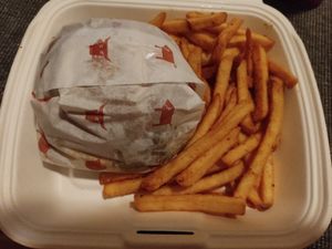 Burger and fries in takeaway box at The Tavern in Prague