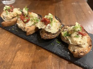 Daily smoked bruschetta appetizer  at Unique (V) Pizzeria SUKHASANA in Osaka