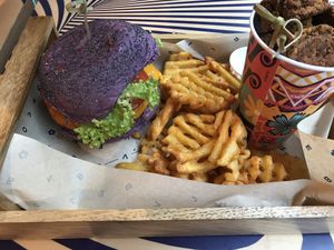Tangy burger, “wedges” and “chicken bites” tasting like bread. Fun colored but poor taste.  at Flower Burger in Amsterdam