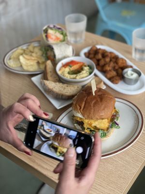 Photo time. Tempeh wrap, Cauliflower buffalo wing, hummus, new plant-based chicken burger with wise meat by Huenic company  at Plant Cafe & Kitchen - Yeonnam in Seoul