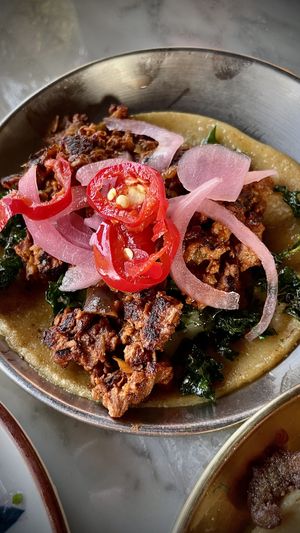 EGGPLANT SOYRIZO
grilled eggplant, soyrizo, crispy kale, pickled onion fermented Fresno chili  at Tu Madre in West Hollywood