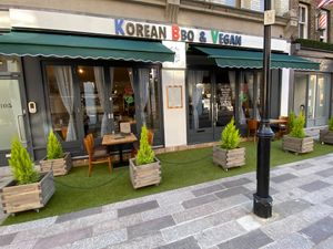 Restaurant front with tables and chairs for customers  at Korean BBQ House- Barbican in London