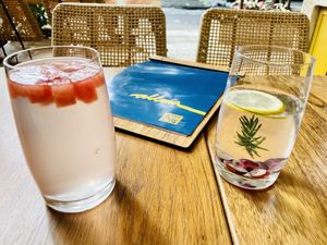 Coconut juice with watermelon and water infused with grapes, lemon and rosemary at Allma Restaurante - Maybe closed in Rio De Janeiro