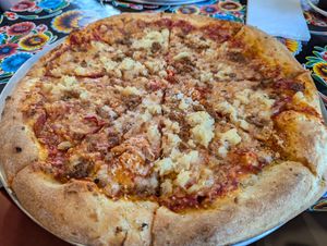Sourdough crust, spicy red sauce, vegan mozzarella, pineapple, and vegan sausage  at La Calavera in Atlanta
